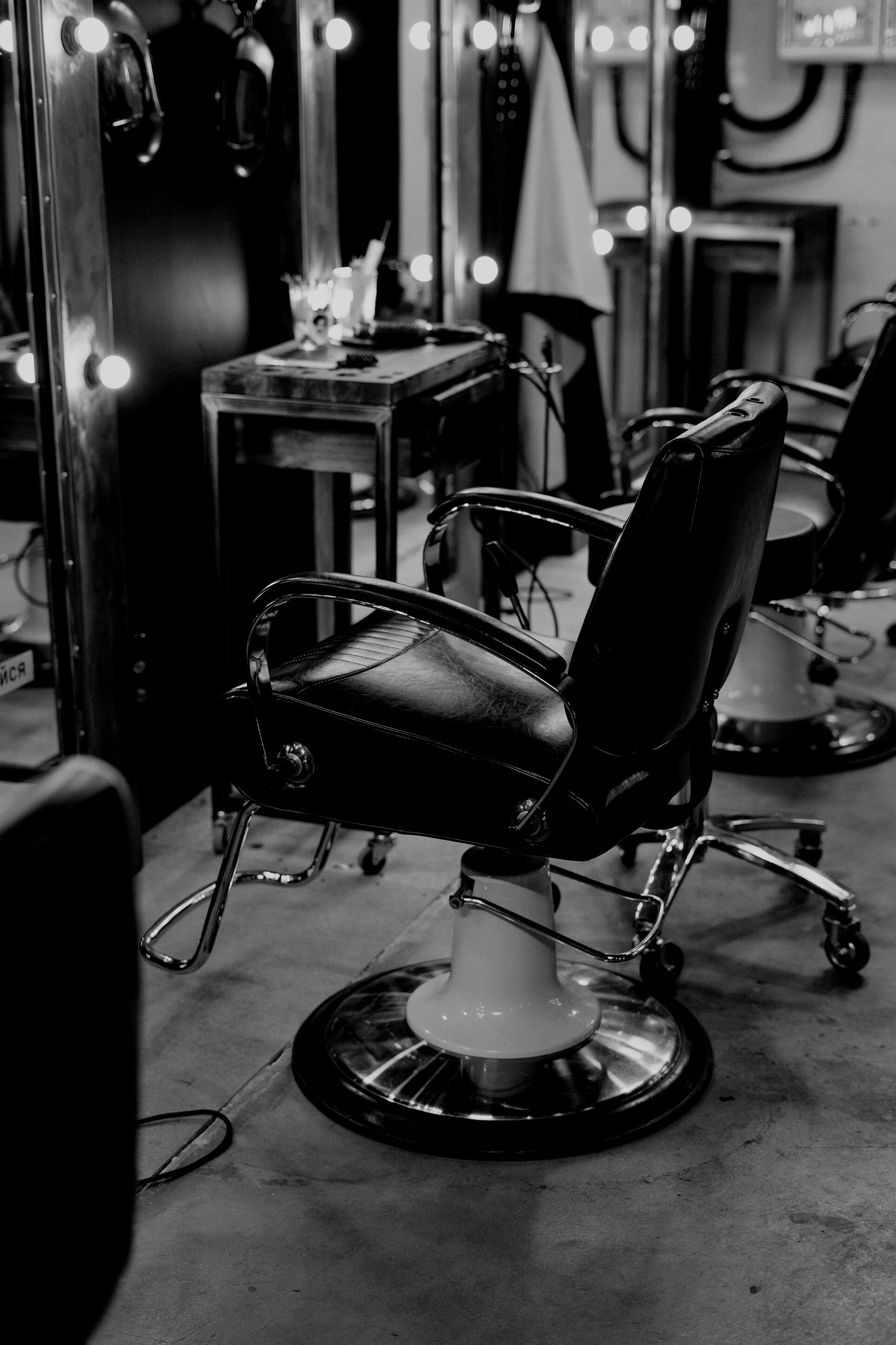 Black Leather Barber Chair in Front of Mirror